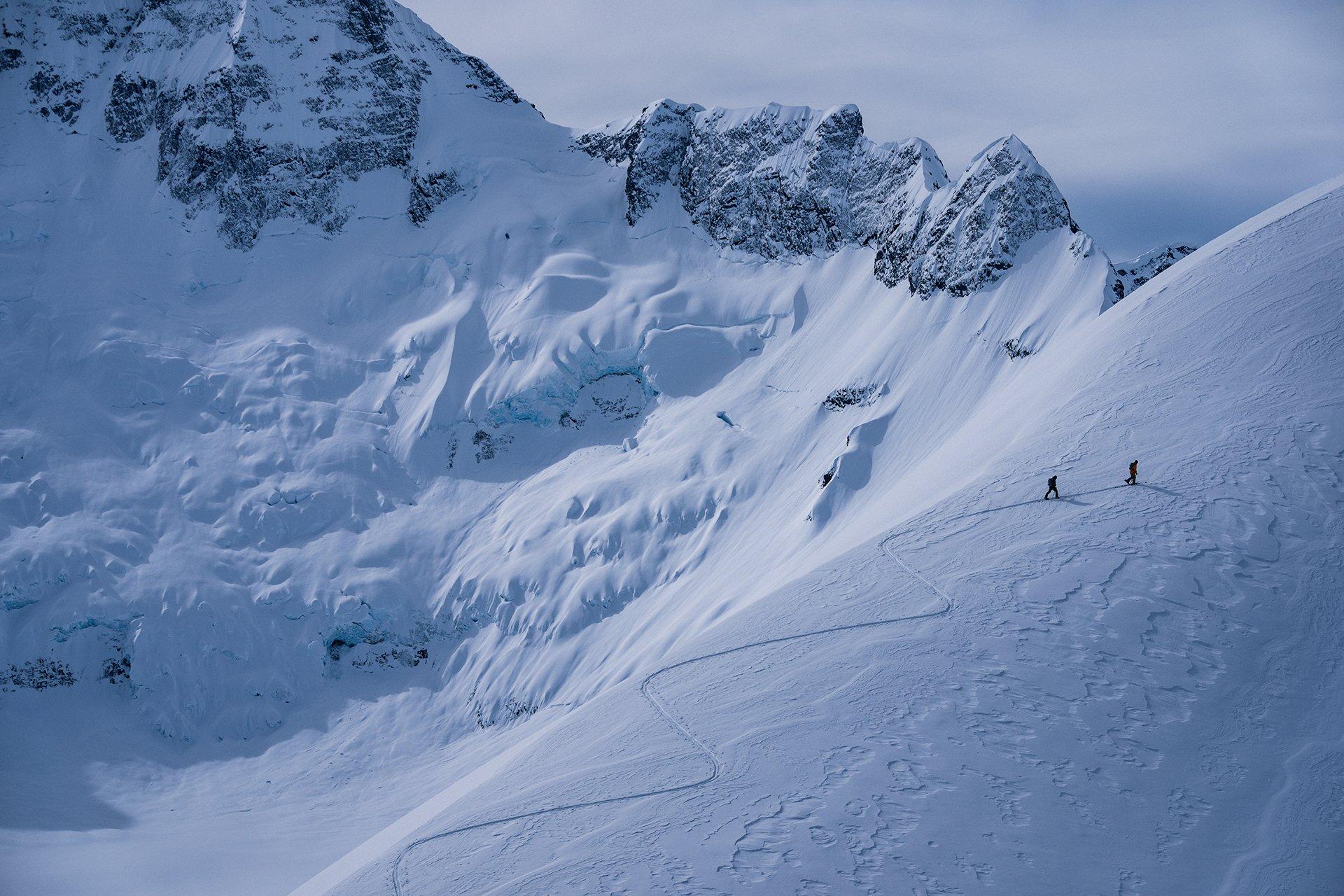 two people ski touring up the mountain in Bella Coola, British Columbia