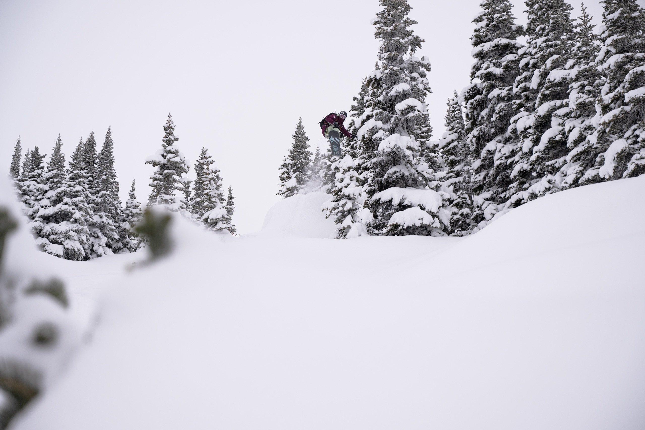 A snowboarder in the air after hitting a ramp