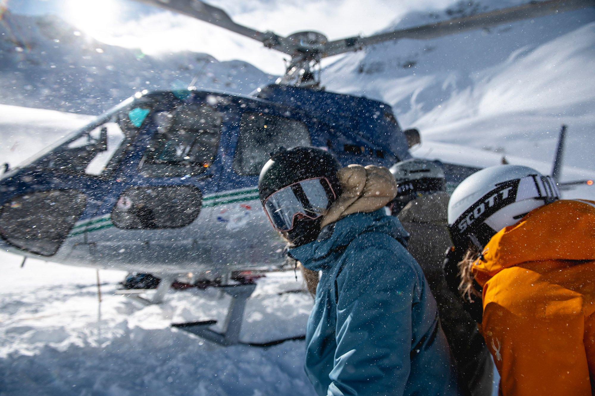 A group of people waiting for a helicopter