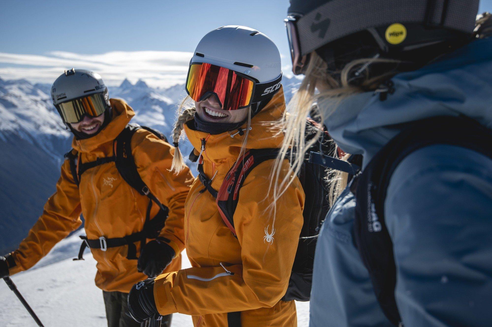 A couple of skiers listening to their guide speak.