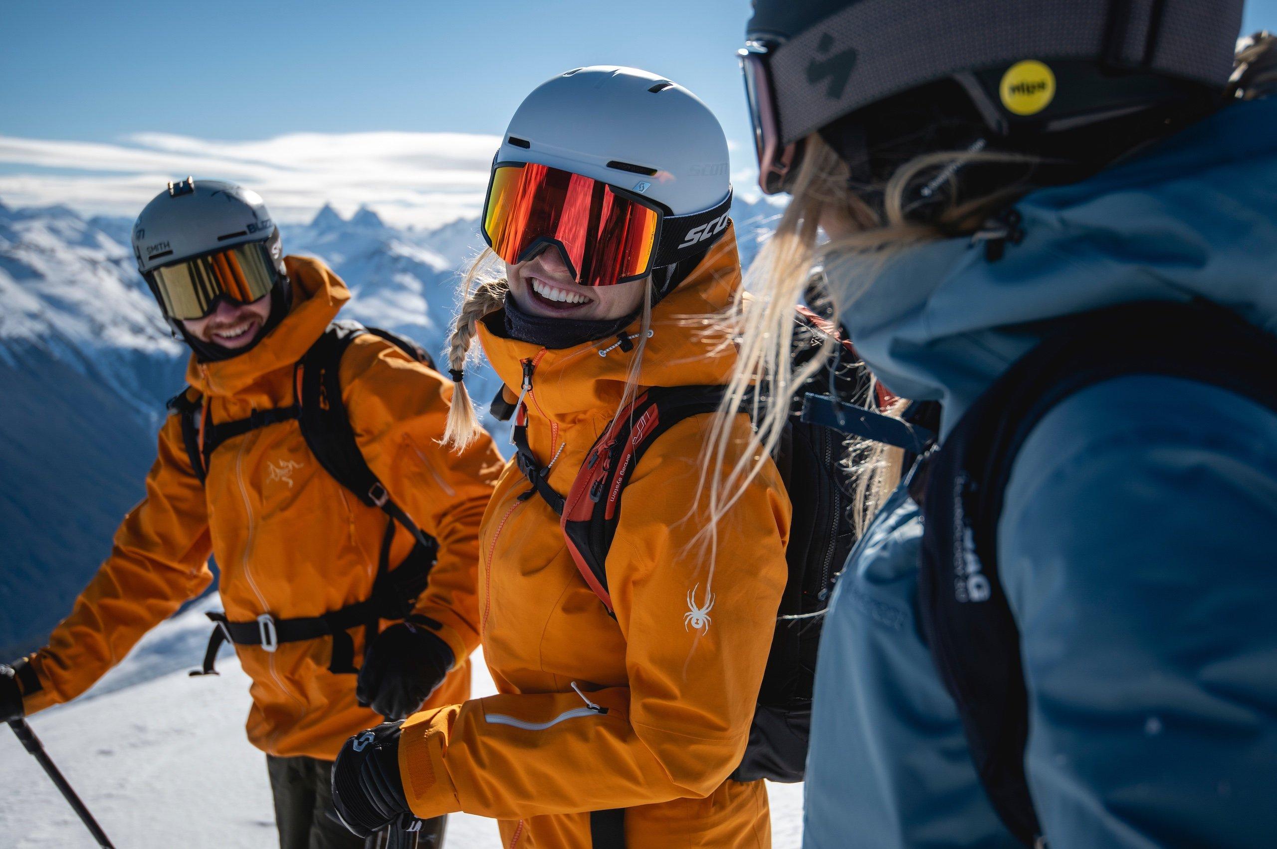 three people stopping to chat while skiing