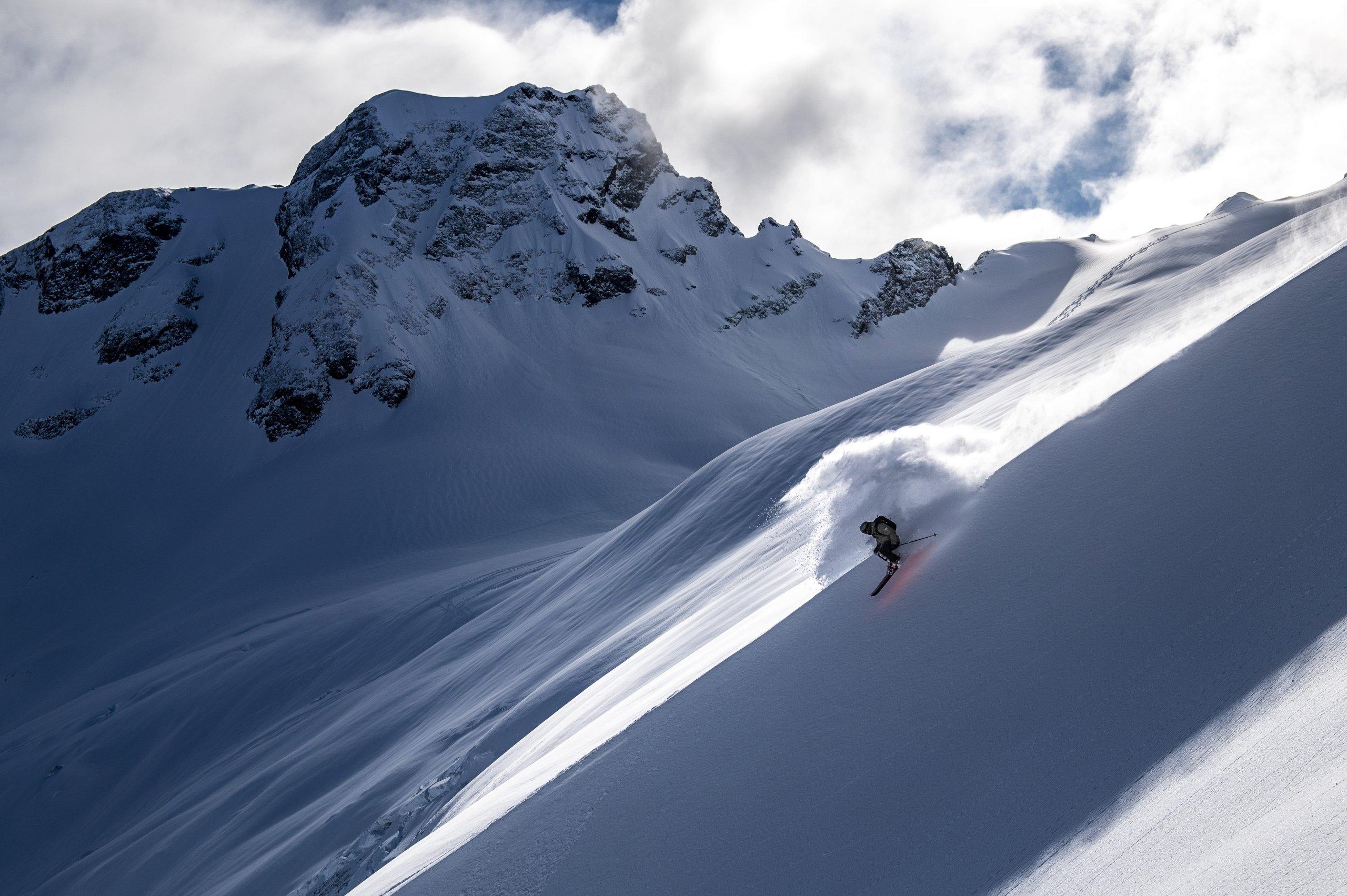 A skier descending a mountain