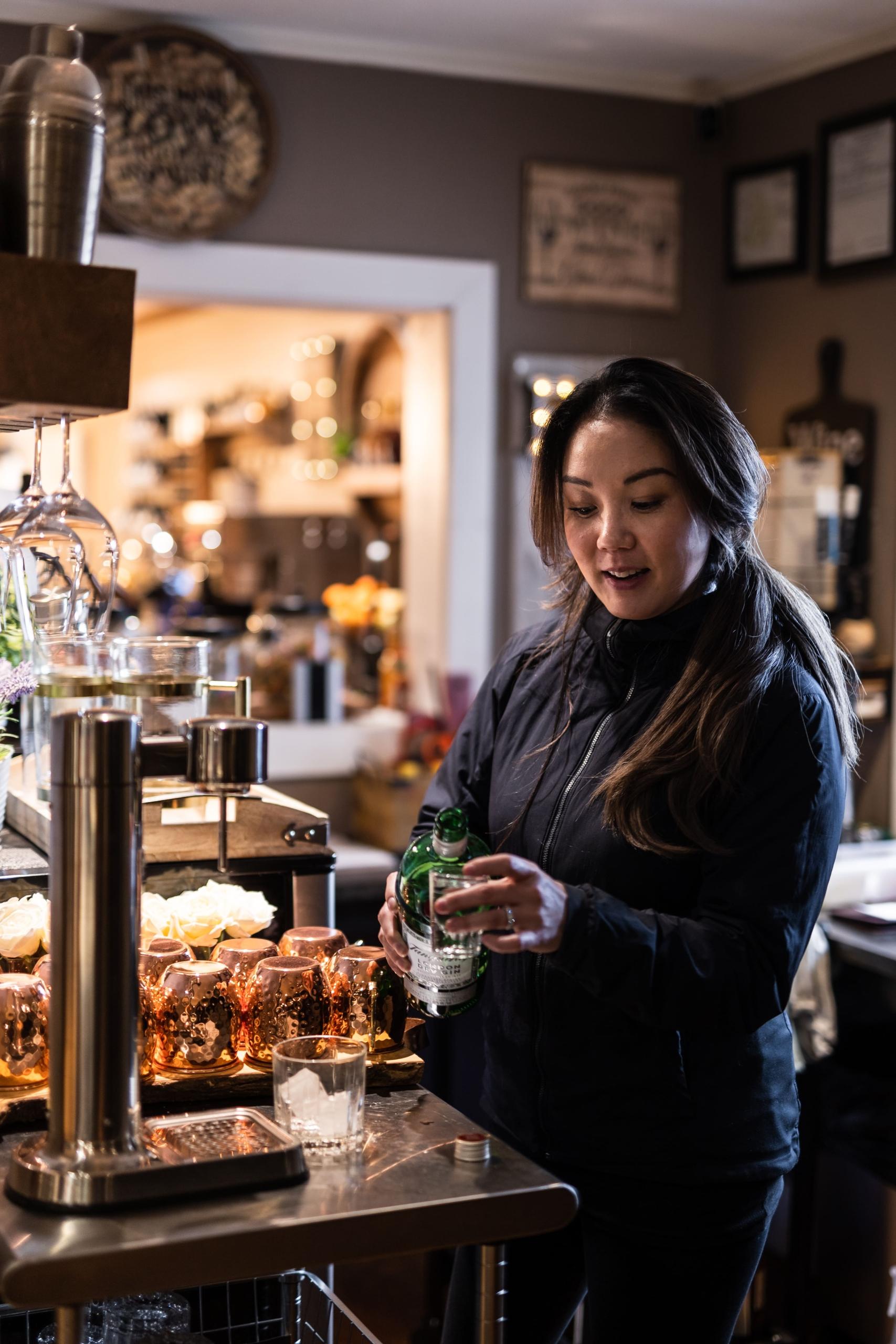 A woman pouring a shot